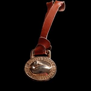 Dooney & Bourke Brass Duck Hangtag